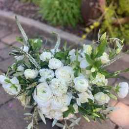 White bouquet of roses and ranunculus with greenery