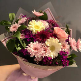 Pink and white mixed bouquet wrapped in pastel paper