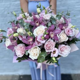 Bouquet of pink and white roses with purple orchids