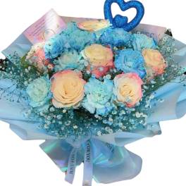 Bouquet of pastel roses and blue carnations with a glittery heart topper