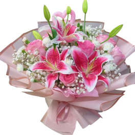 Pink lilies and roses wrapped in pale pink paper