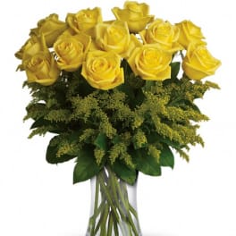 Yellow roses arranged in a clear glass vase