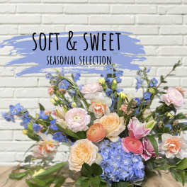 Mixed bouquet of pastel flowers with blue hydrangeas and pink roses