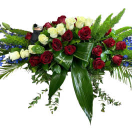 Long floral spray of red and white roses with blue accents
