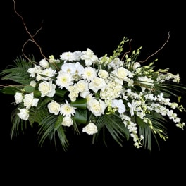 White floral arrangement with roses, orchids, and chrysanthemums