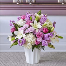 Pink and white floral arrangement in a white vase