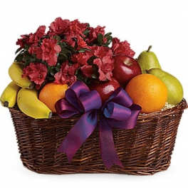 Fruit basket with red flowers and a purple ribbon