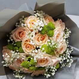 Bouquet of peach roses with white baby's breath and green button mums