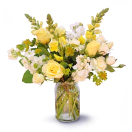 Yellow and white flower bouquet in a glass jar vase
