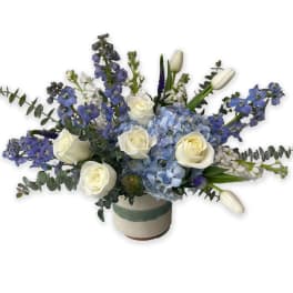 Blue and white floral arrangement in a ceramic vase