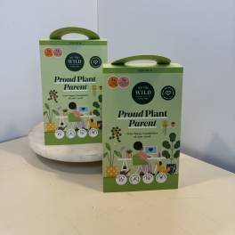 Two green plant care gift boxes on a table