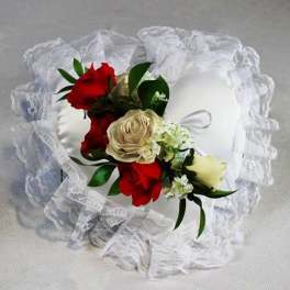 White satin ring pillow with red and cream roses