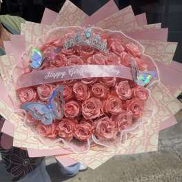 Pink rose bouquet with a tiara and butterfly decorations