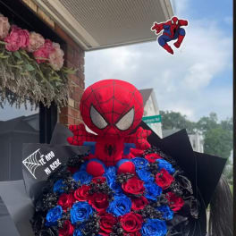 Spider-Man plush atop a bouquet of red and blue roses