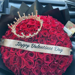 Heart-shaped bouquet of red roses with a jeweled crown and Valentine ribbon