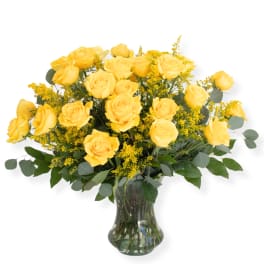 Yellow roses arranged in a clear glass vase