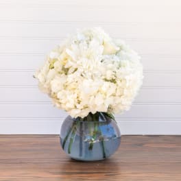 White flower bouquet in a blue glass vase