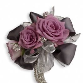 Lavender rose corsage with dark ribbon and silver accents