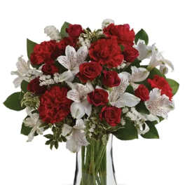 Red and white mixed bouquet in a clear glass vase