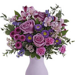 Lavender and pink mixed bouquet in a light purple vase