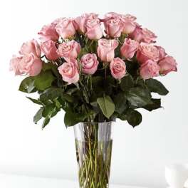 Pink roses arranged in a clear glass vase