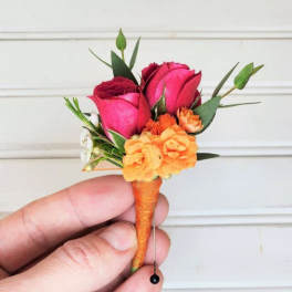 Small boutonniere with pink roses and orange flowers