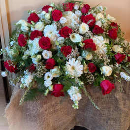 Large red and white rose arrangement with daisies and hydrangeas