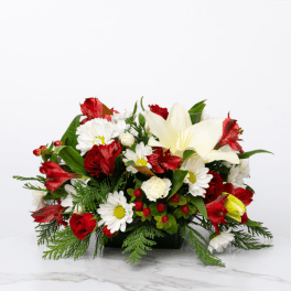 Red and white floral arrangement in a black container