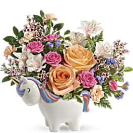Floral arrangement in a unicorn-shaped ceramic container