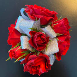 Cluster of red roses tied with silver ribbon