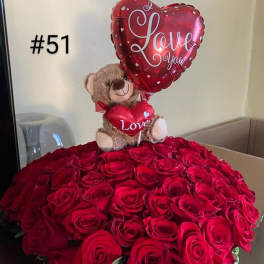 Red rose arrangement with a teddy bear and heart-shaped balloons