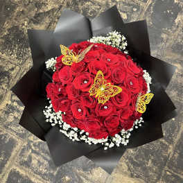 Red rose bouquet with white baby's breath and yellow butterfly decorations
