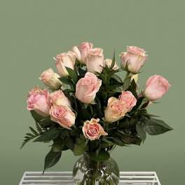 Pink roses arranged in a clear glass vase