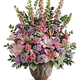 Pink and lavender floral arrangement in a decorative vase