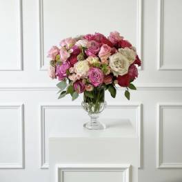 Pink and white rose bouquet in a clear glass vase