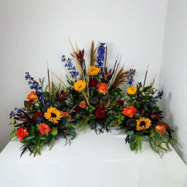 Colorful floral casket spray with roses and sunflowers