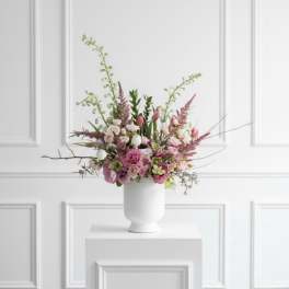 Pink and white floral arrangement in a white vase