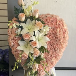 Heart-shaped pink floral standing spray with roses and lilies