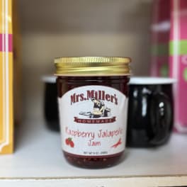 Jar of raspberry jalapeño jam with a gold lid