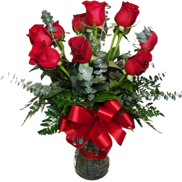 Red roses in a glass vase with a red ribbon bow