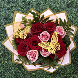 Bouquet of red and pink roses with gold butterfly decorations