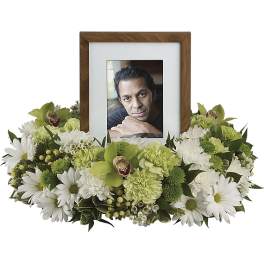Framed photo surrounded by white and green flowers