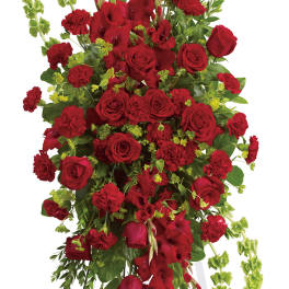 Tall red floral standing spray on a white easel