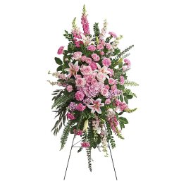 Tall pink floral standing spray on an easel