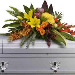 Colorful floral spray on a silver casket