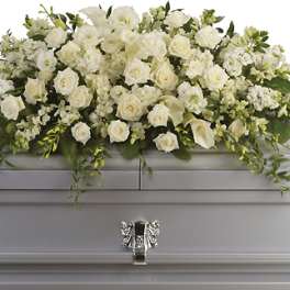 White floral casket spray with roses and calla lilies