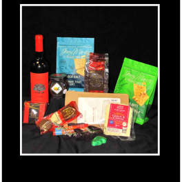 Assorted wine and snack gift items arranged on a black background