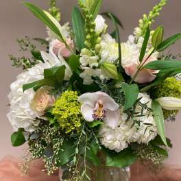 Bouquet of white and pale pink flowers in a glass vase
