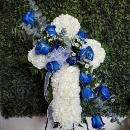White floral standing spray with blue roses and ribbon