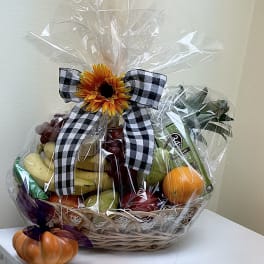 Fruit basket with a sunflower bow and a small pumpkin decoration